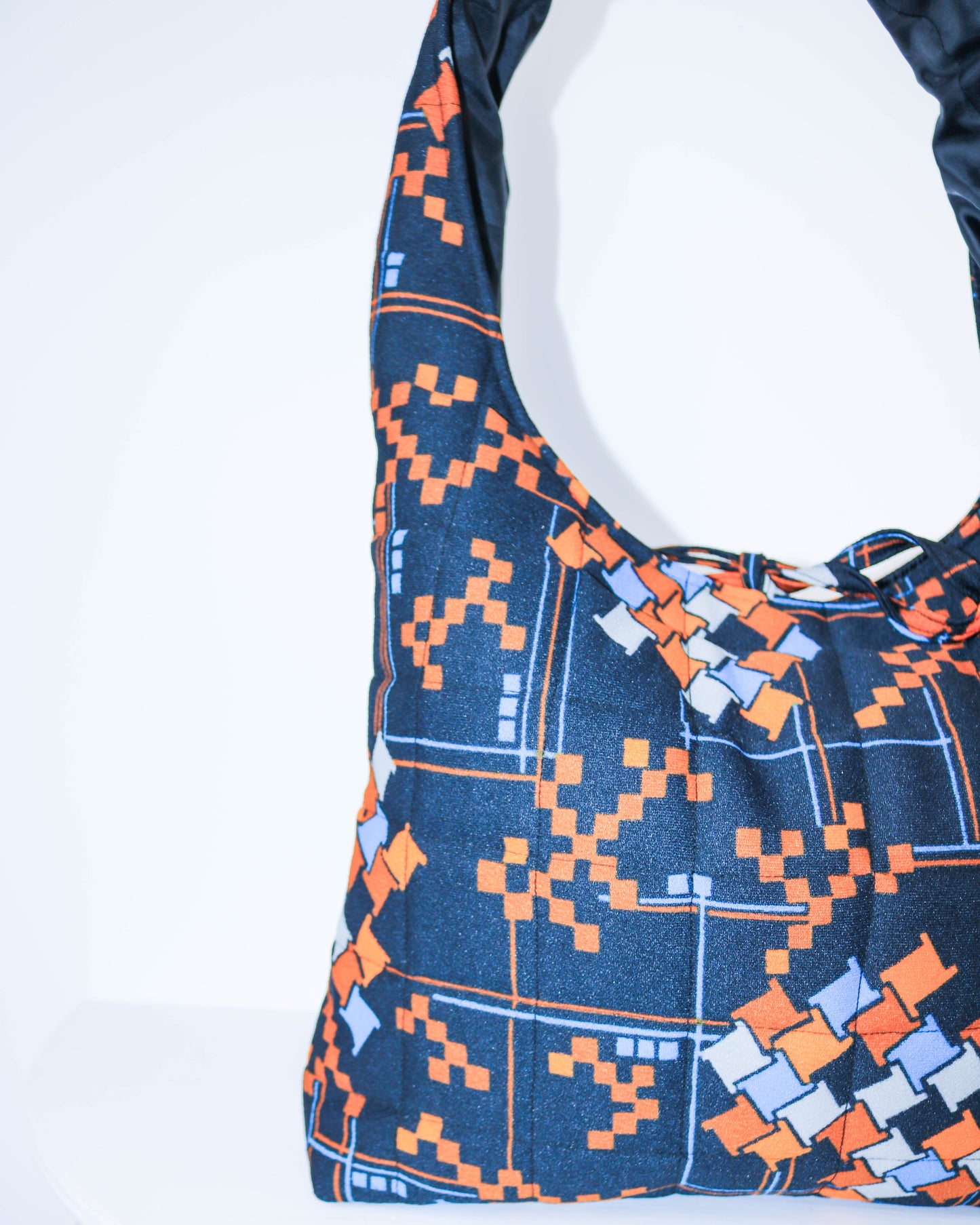 Blue and orange patterned bag on a white background
