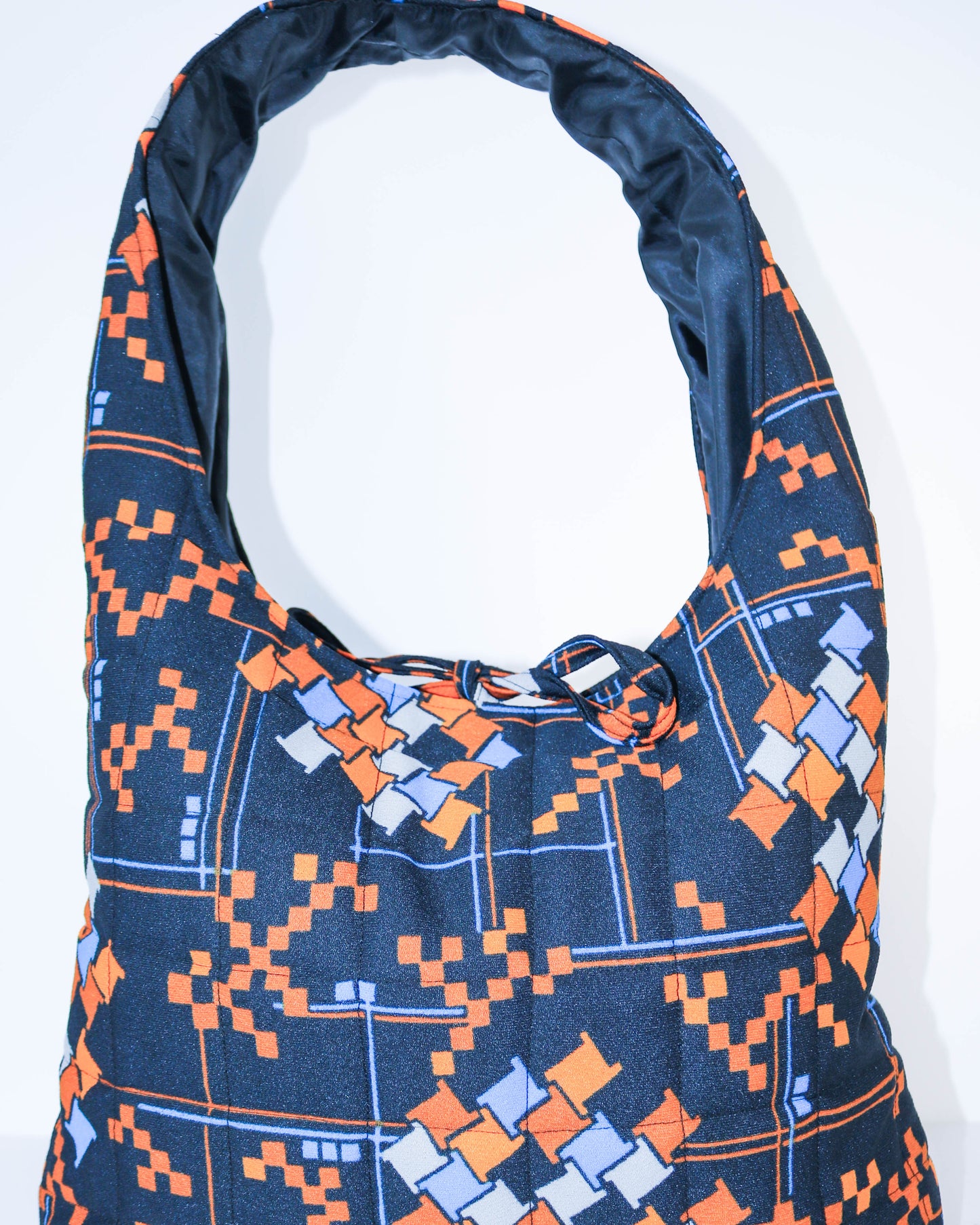 Blue and orange patterned bag on a white background