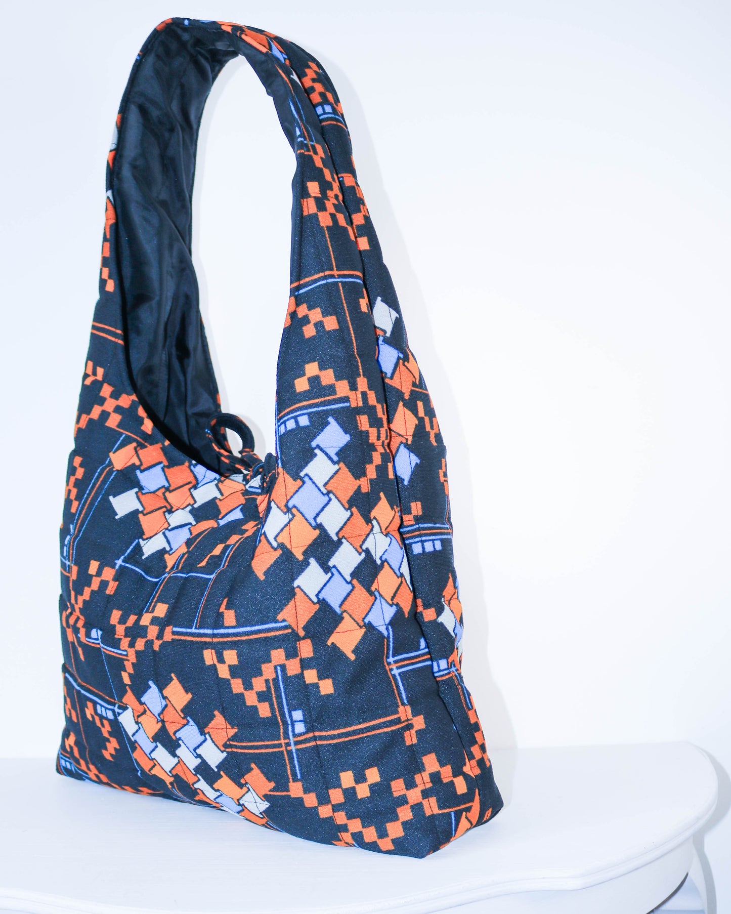 Blue and orange patterned bag on a white background