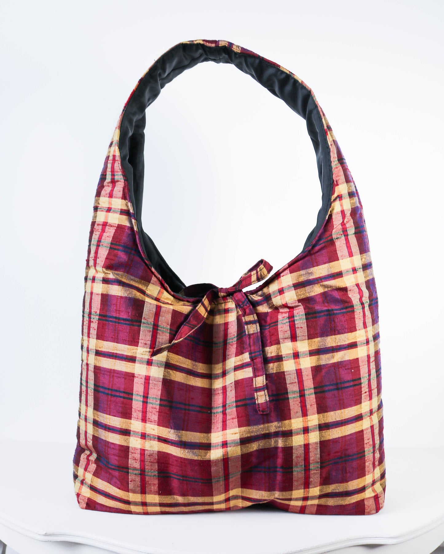 Plaid patterned bag on a white background