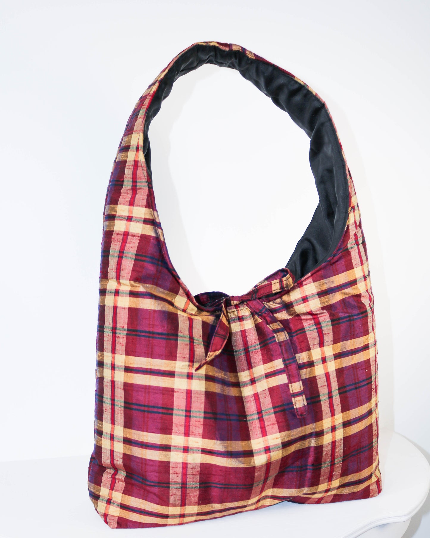 Plaid bag with red and yellow pattern on a white background