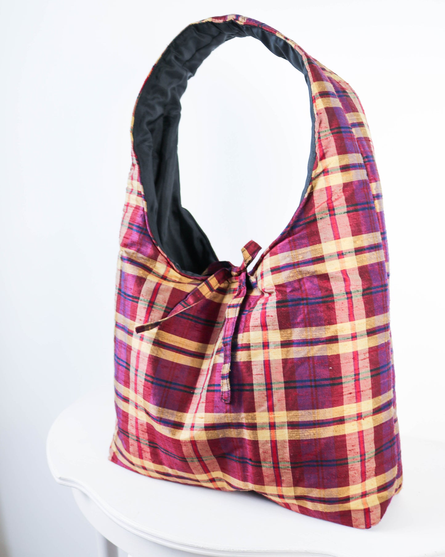 Plaid bag with a black interior on a white background