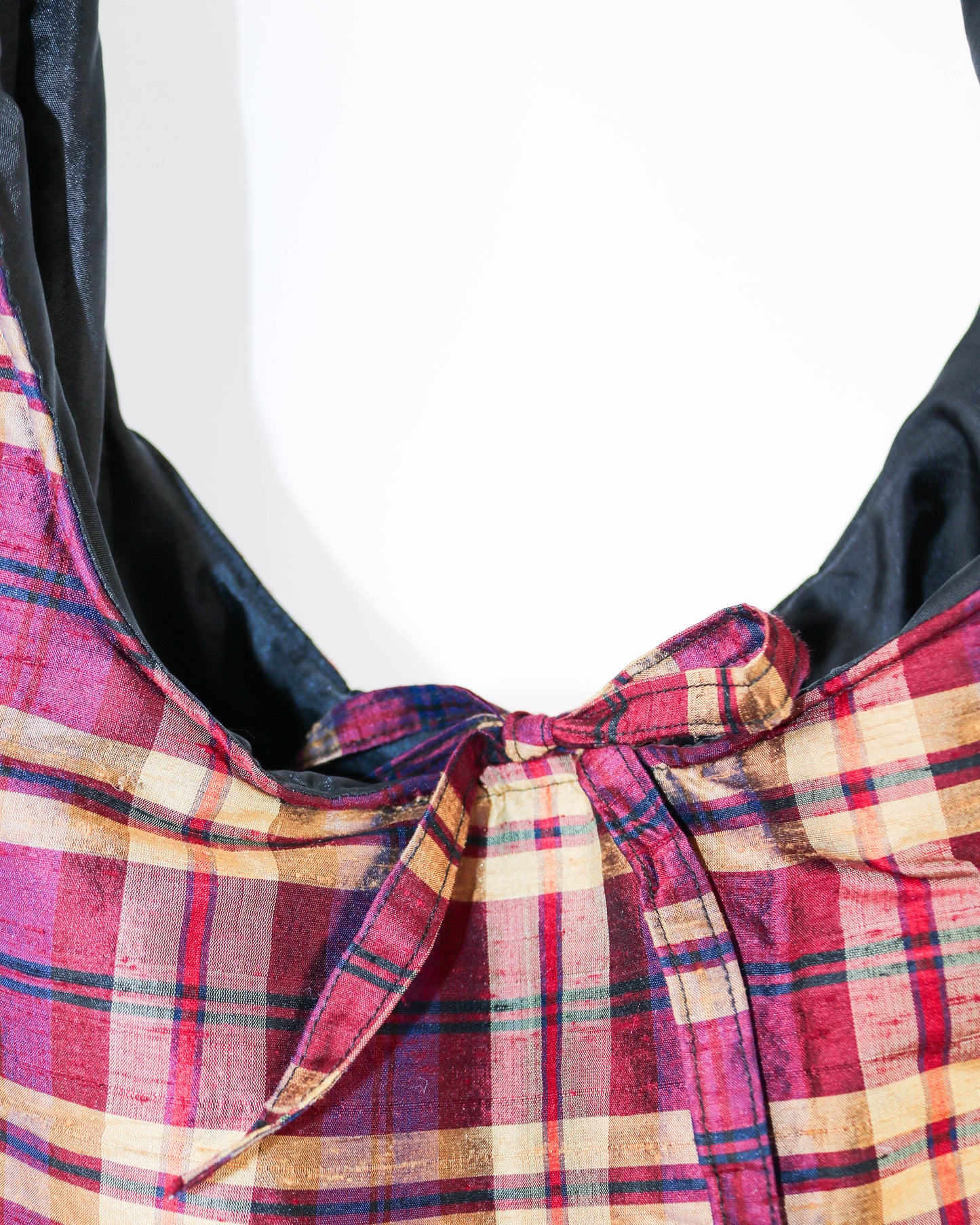 Close-up of a plaid fabric with a bow on a white background