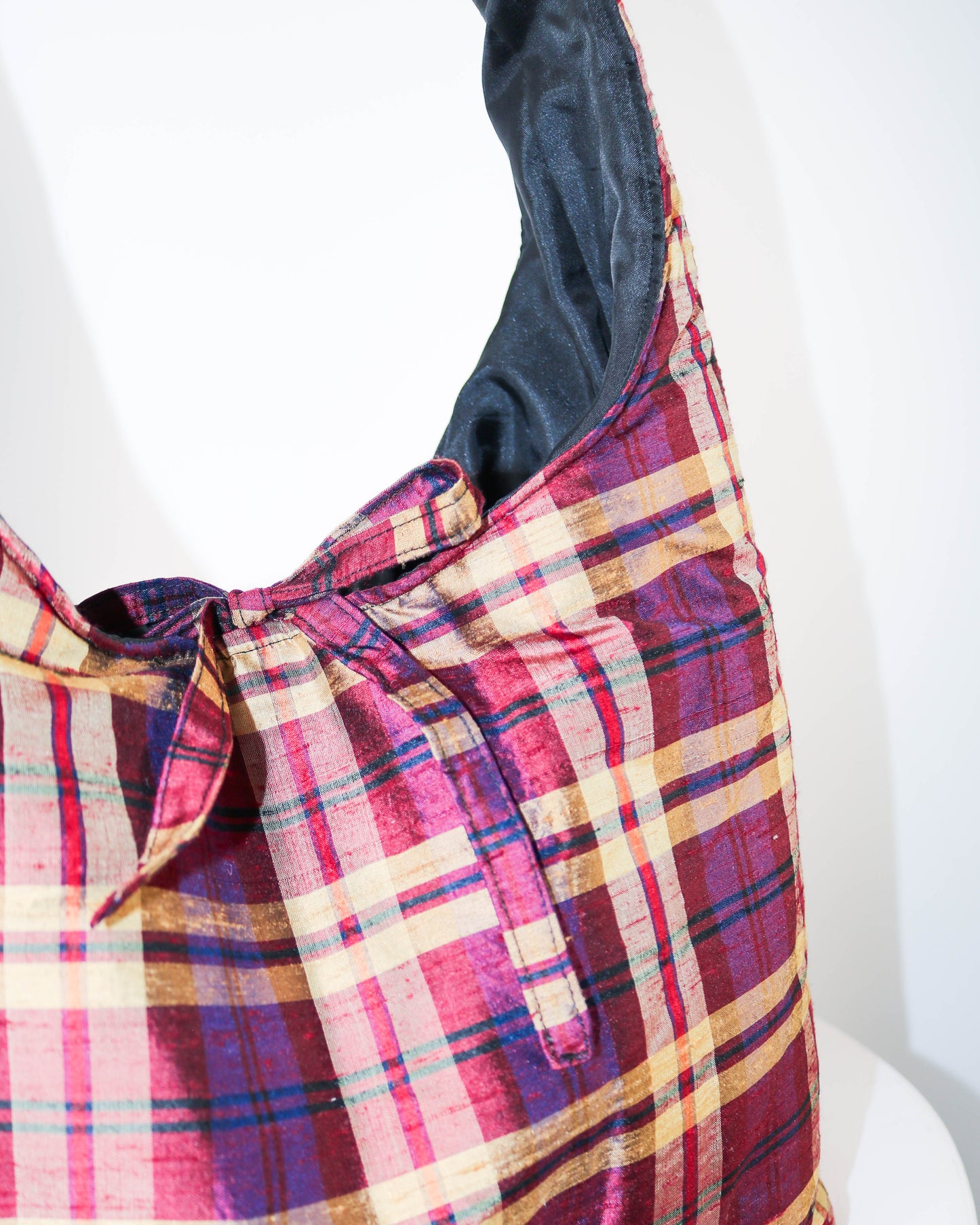 Plaid bag with a colorful pattern on a white background