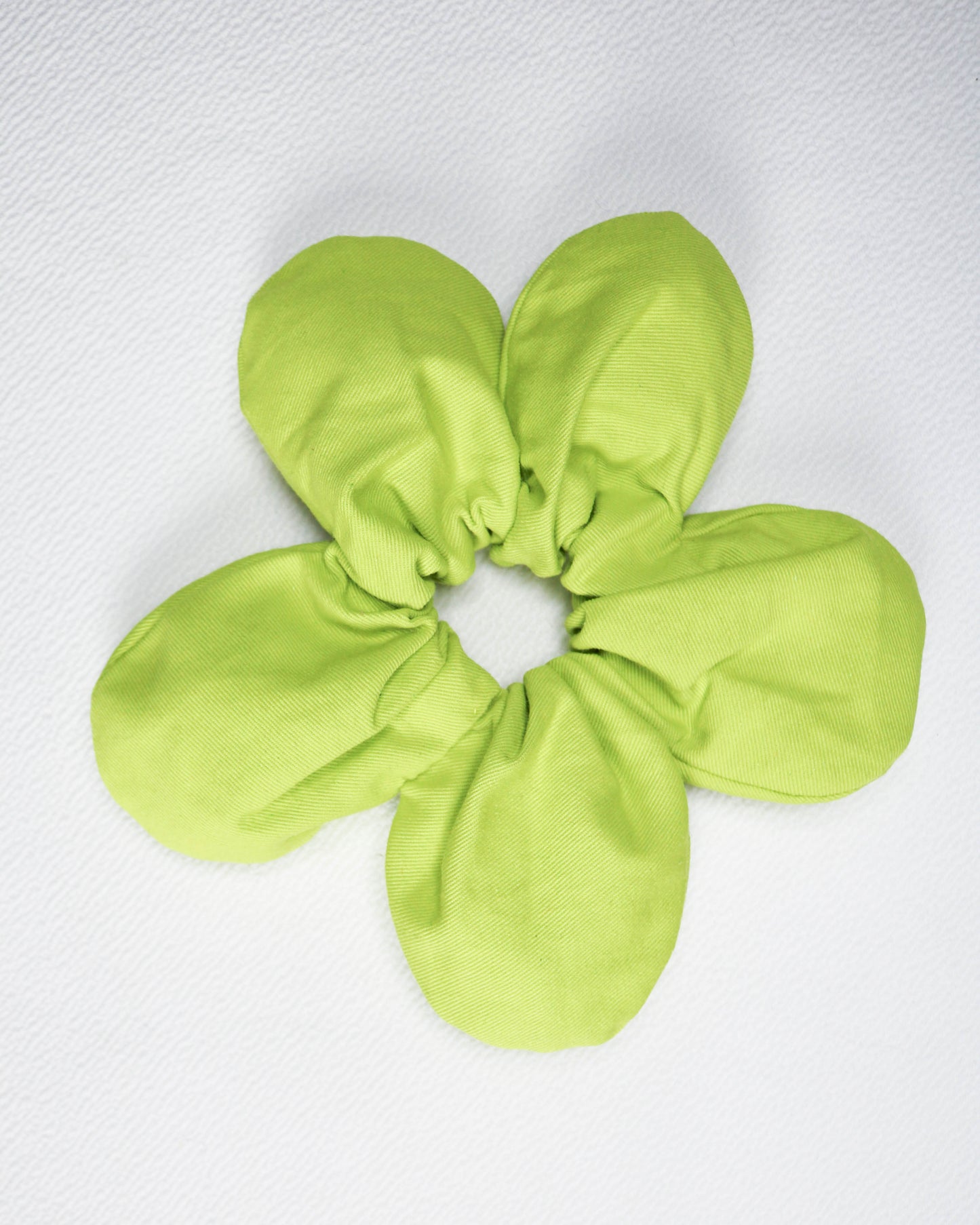 Green scrunchie on a white background