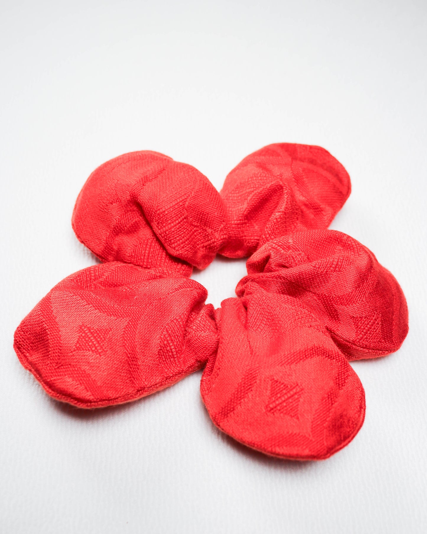Red scrunchies on a white background