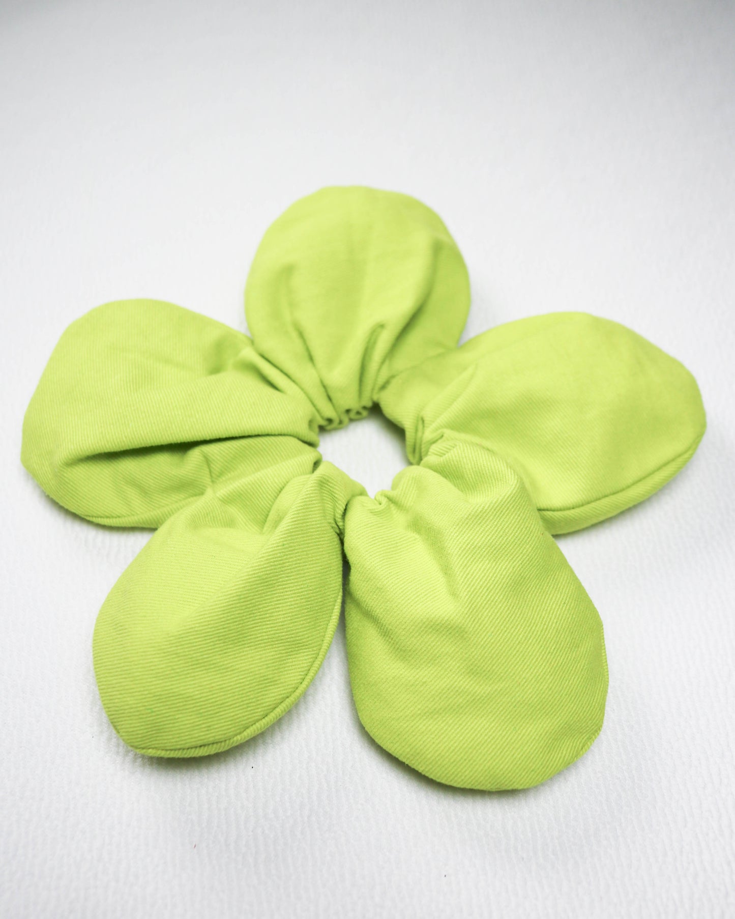 Green scrunchie on a white background