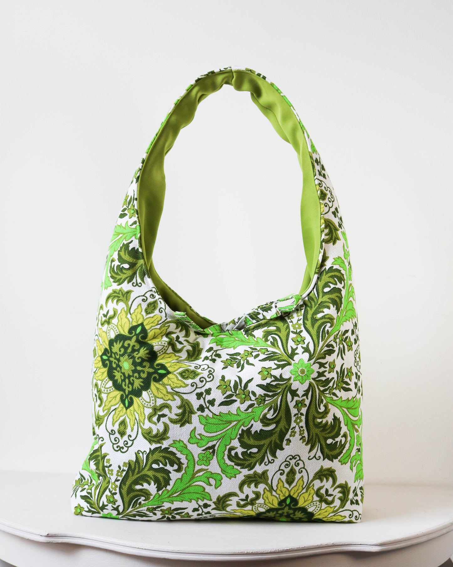 Green and white patterned bag on a white background
