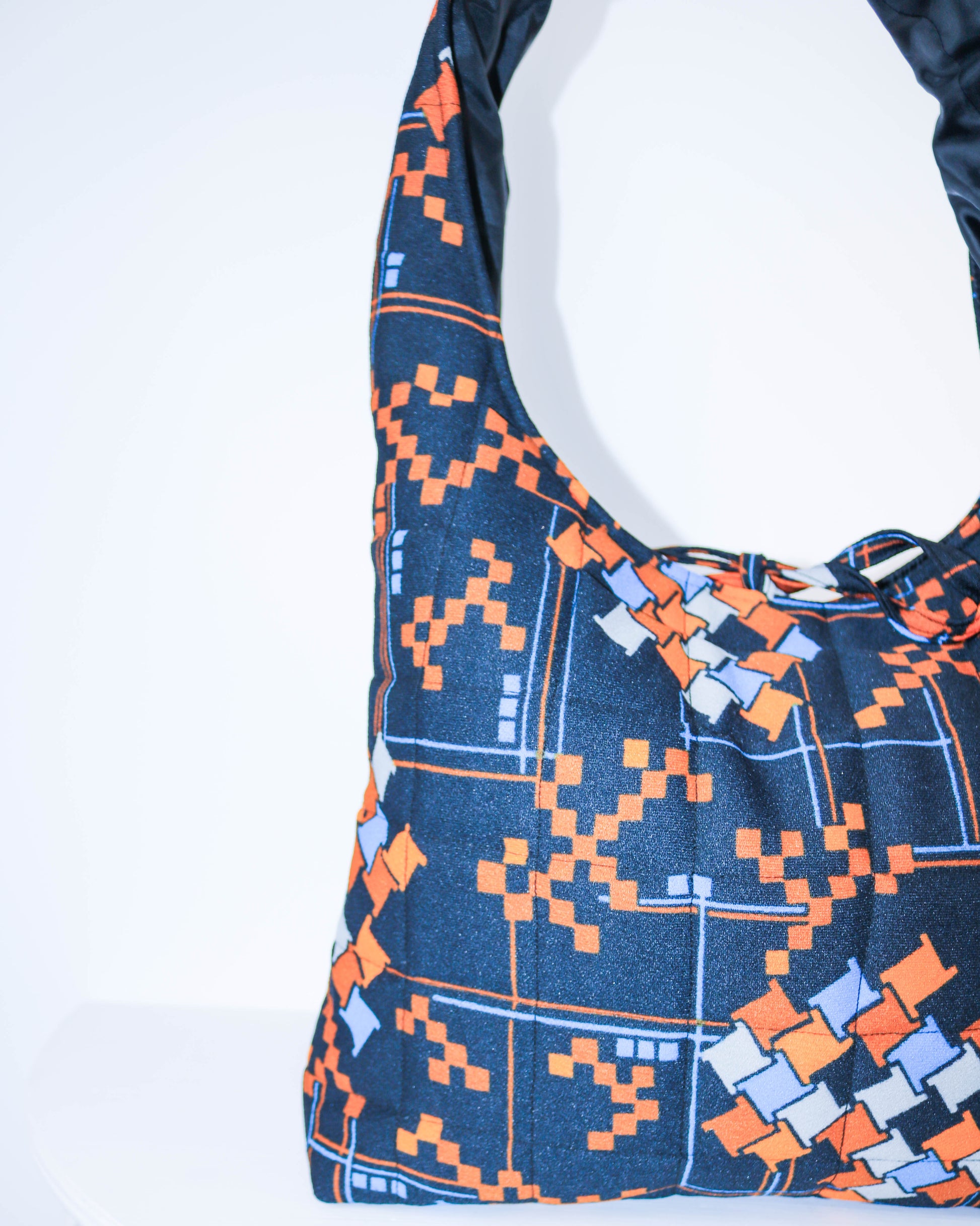 Blue and orange patterned bag on a white background