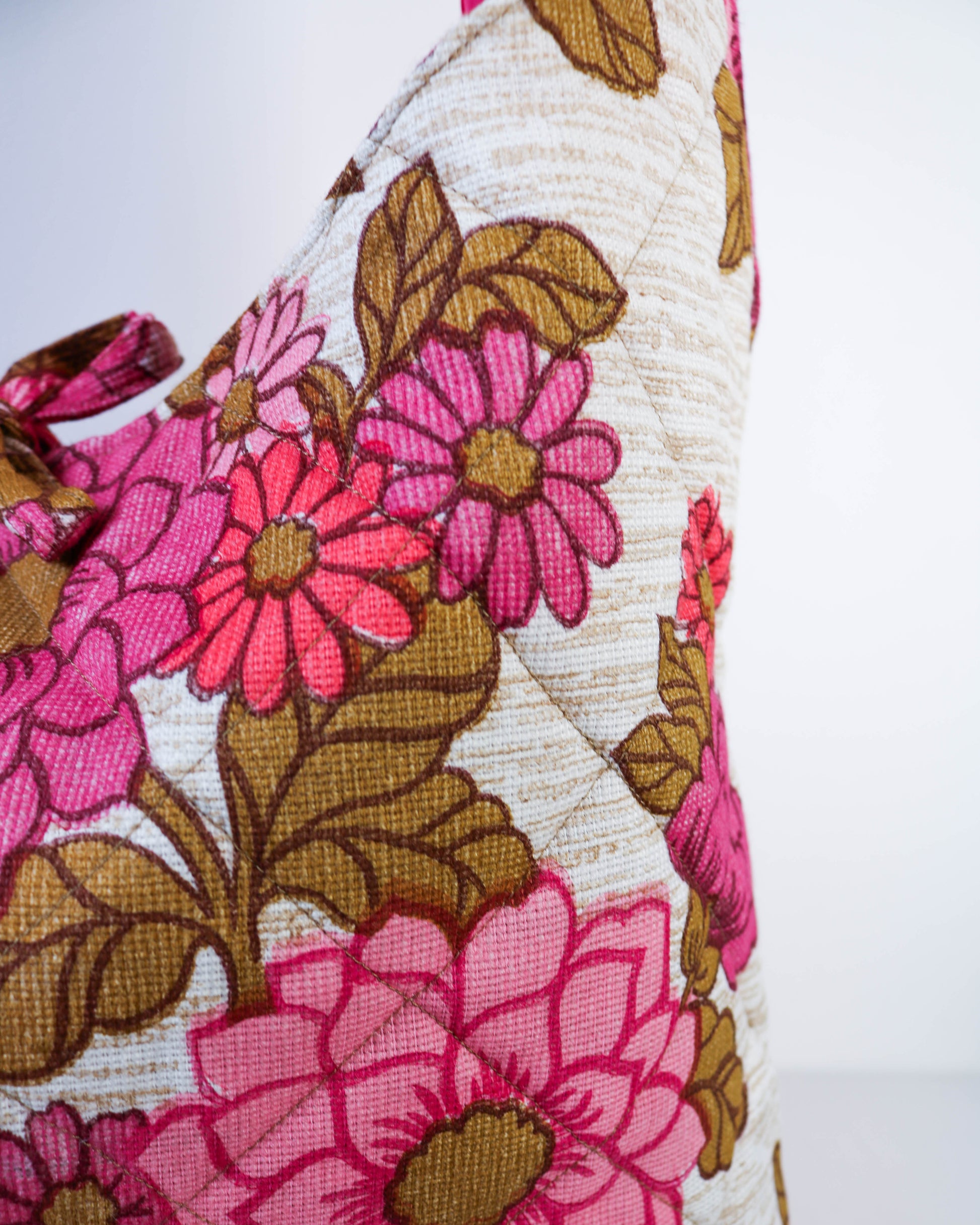 Floral fabric with pink flowers and brown leaves on a white background