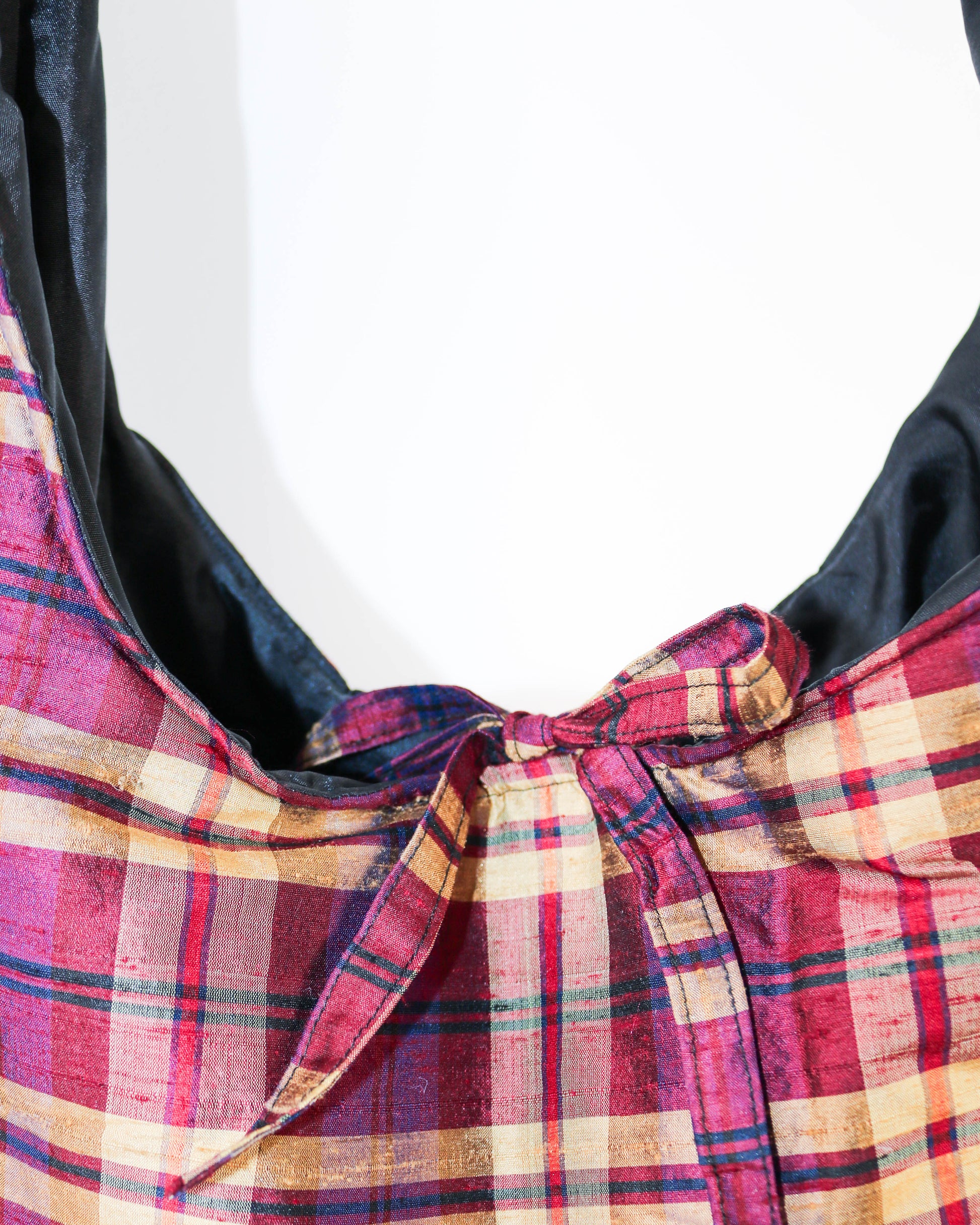 Close-up of a plaid fabric with a bow on a white background