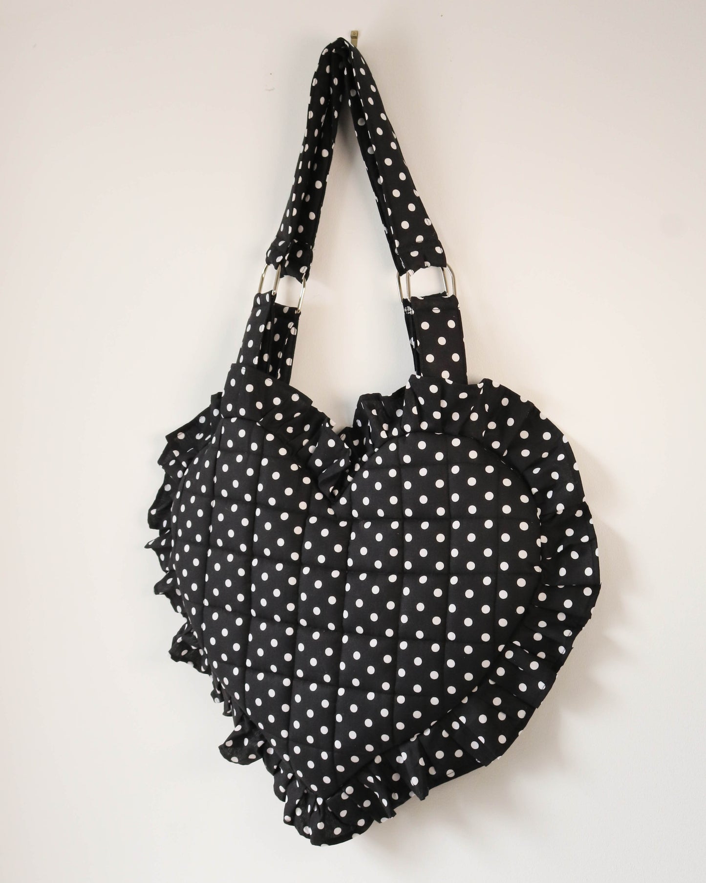 Black polka dot handbag on a white background