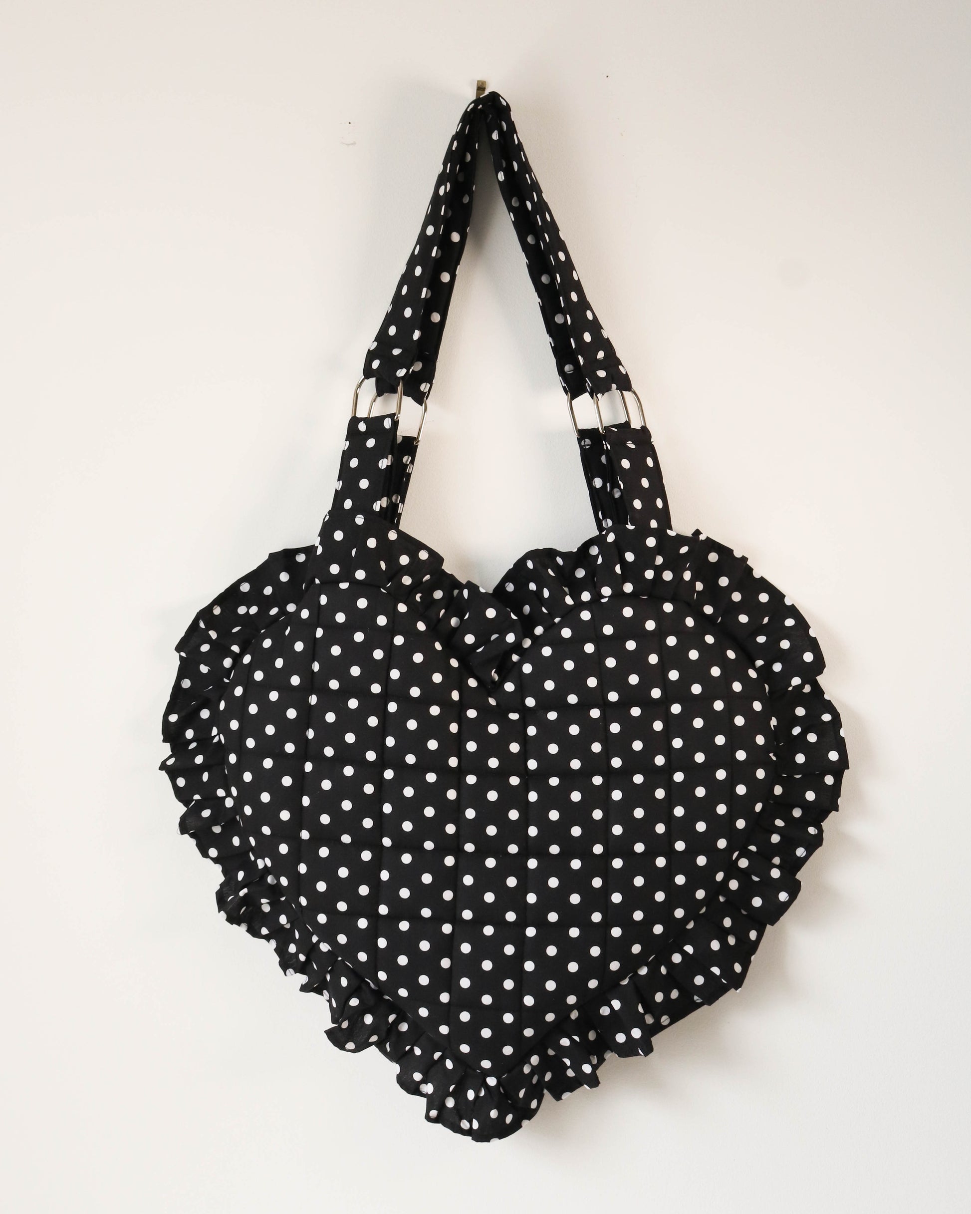 Black polka dot handbag on a white background