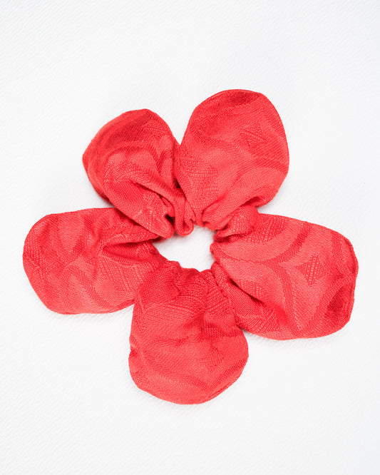 Red textured scrunchie on a white background