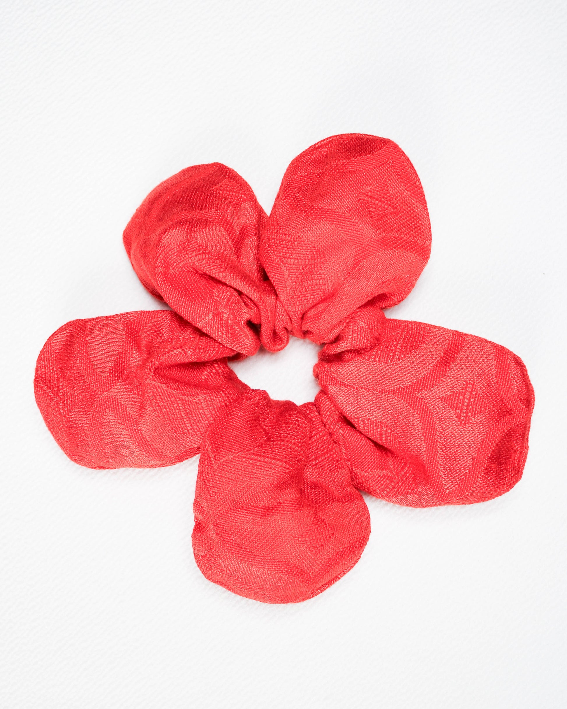 Red textured scrunchie on a white background