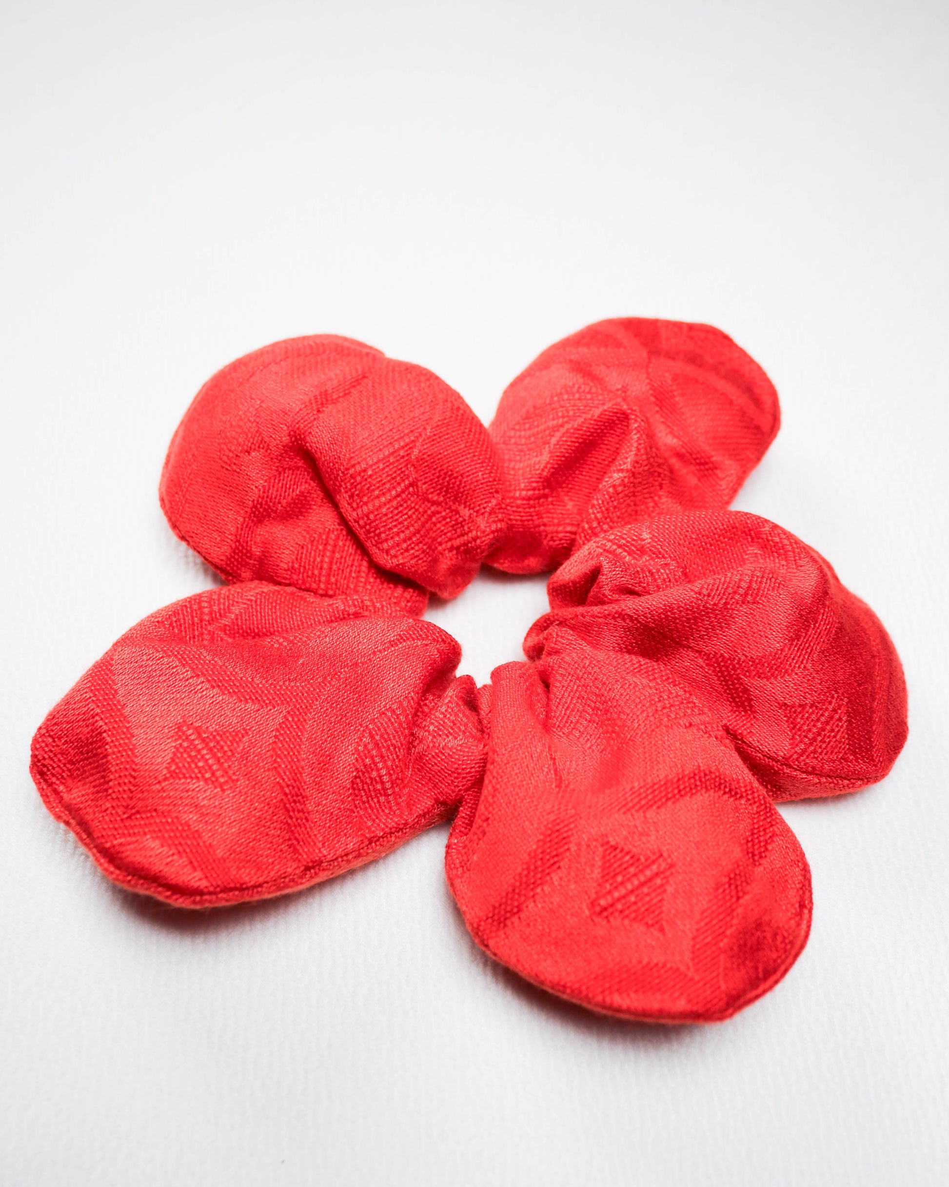 Red scrunchies on a white background