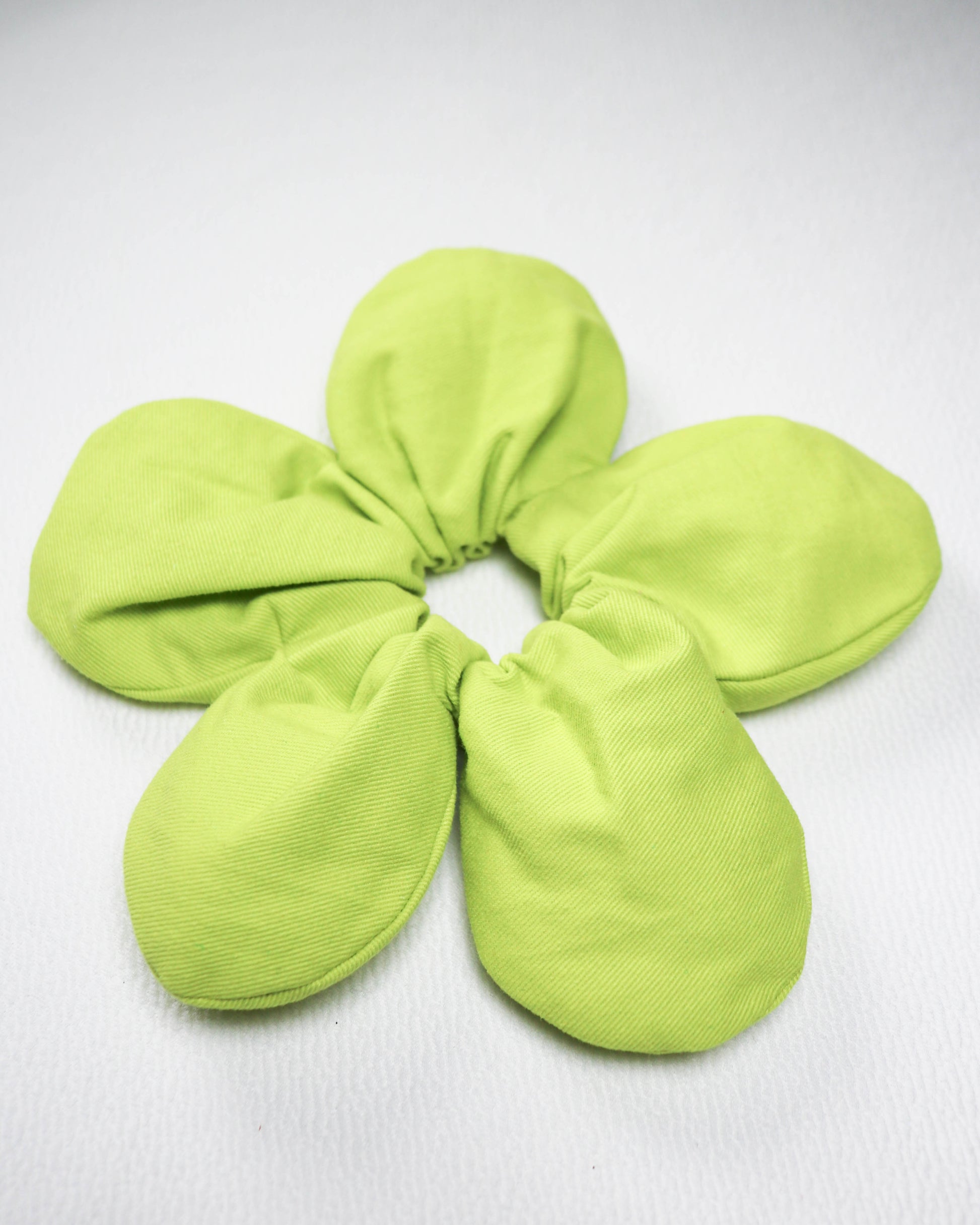 Green scrunchie on a white background