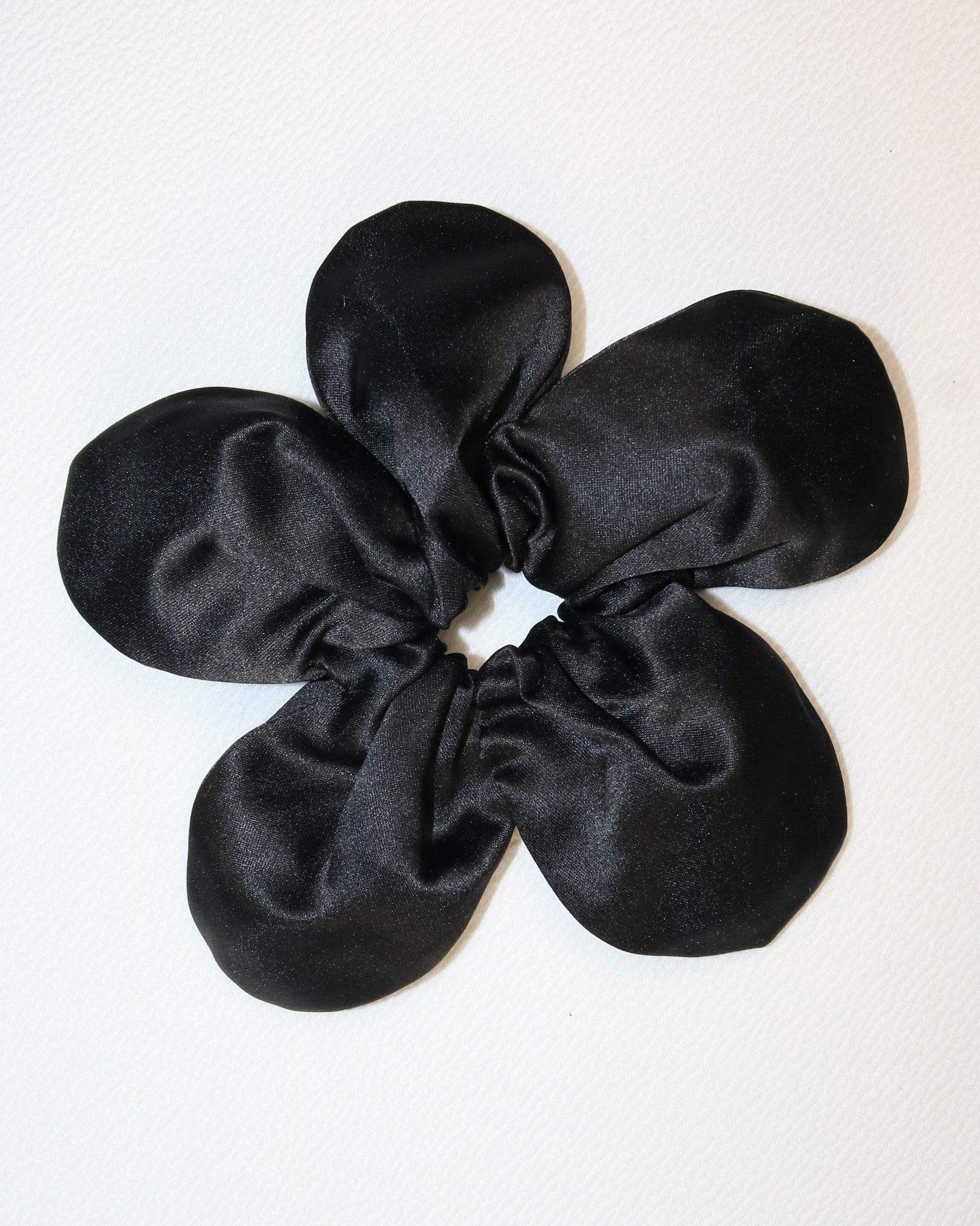 Black satin scrunchie on a white background