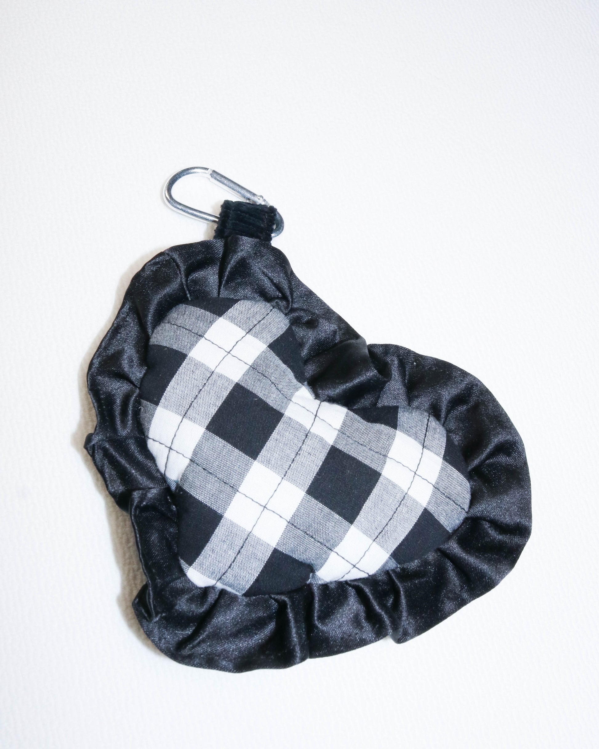 Black and white checkered bag charm
with drawstring on a white background