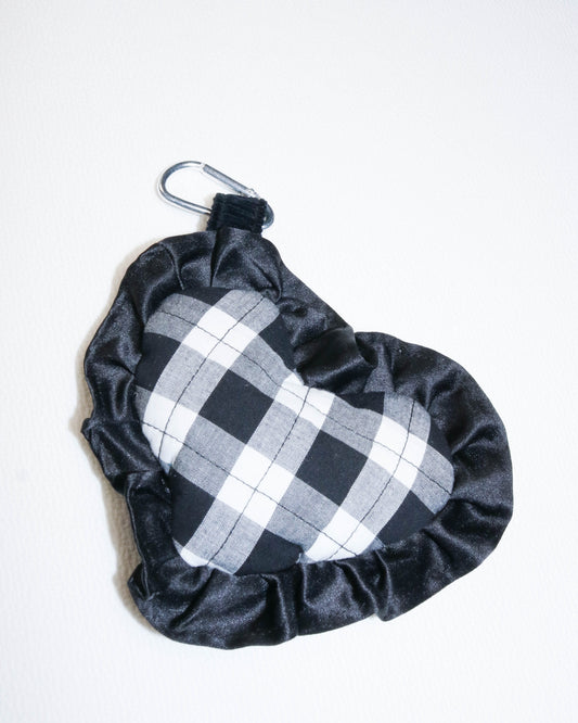 Black and white checkered bag charm
with drawstring on a white background