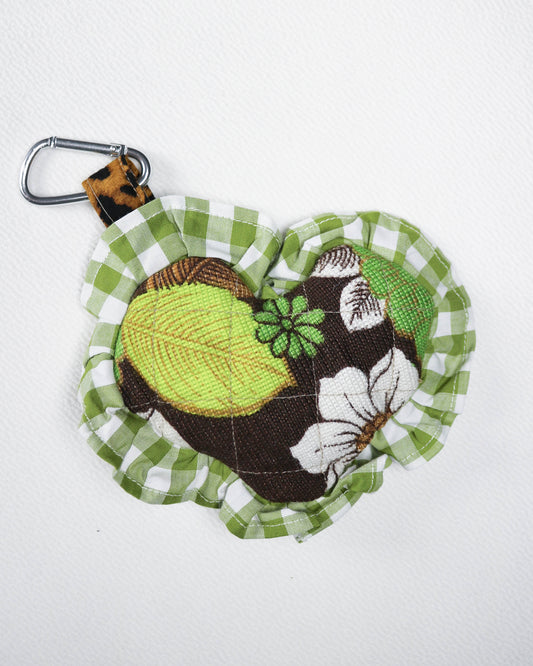 Fabric key fob with green and brown design on a white background
