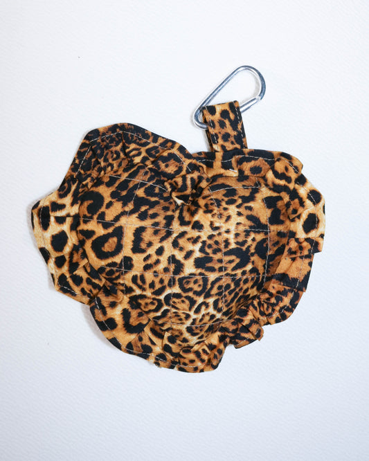 Leopard print charm  with a carabiner on a white background